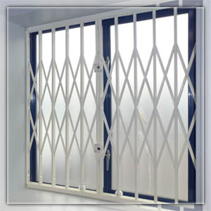 Colapsible Gate covering window in London. Retractable grille, in closed position.